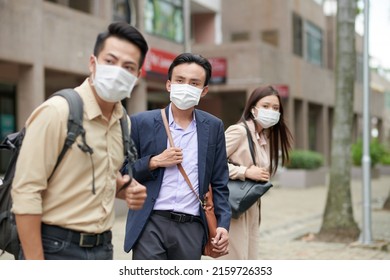 Vietnamese Businesssman In Suit And Medical Mask Looking On Road When Waiting For Taxi Car Or Bus