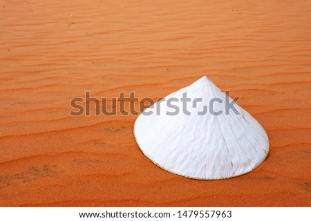 Vietnamese conical hat isolated on a red desert, the traditional conical hats of Vietnam girl, wave texture on the red desert., background, wallpaper, Vector background, Empty, landscape.