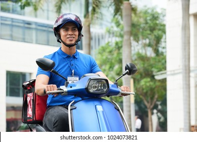 Vietnamese Delivery Man Riding On Scooter