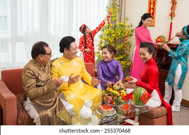 Vietnamese Family Preparing For Tet Celebration