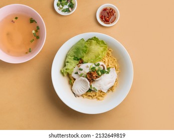 Vietnamese Food Sliced Fish Noodle In A Bowl With Soup, Chili Sauce And Spring Onion Top View On Wooden Table