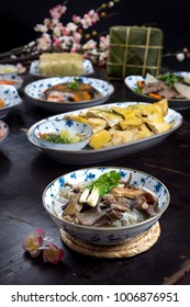 Vietnamese food for Tet holiday in spring, it is traditional food on lunar new year: soya noodles soup, boiled chicken, fried vegetable, jellied meat, chung cake