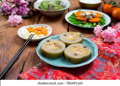Vietnamese food for Tet holiday in spring, it is traditional food on lunar new year: Cylindric glutinous rice cake, dried shrimp, pickled small leeks, soup of bitter melon stuffed, fried vegetables