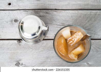 Vietnamese Ice Coffee With Condensed Milk, Cafe Sua Da On A Wooden Background