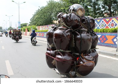 Vietnamese Motor Driving On Highway Packed With Way Too Much Luggage. Rear View, Two Scooters Fully Loaded With Pottery. Unsafe Luggage Examples, Dangerous. 