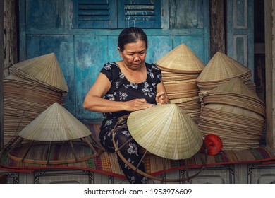 Vietnamese Old woman craftsman making the traditional vietnam hat in the old traditional house in Ap Thoi Phuoc village, Hochiminh city, Vietnam, traditional artist concept - Powered by Shutterstock