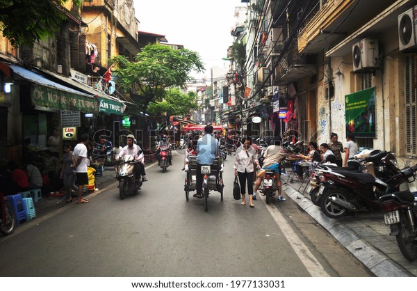 Vietnamese people riding biking driving and\
foreign travelers walking travel visit old town and shopping local\
product in Hanoi 36 Streets Old Quarter at Hoan Kiem on April 12,\
2016 in Hanoi,\
Vietnam