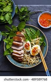 Vietnamese Pho With Duck With Crispy Skin, Bean Sprouts And Egg, Chili Sauce And Herbs