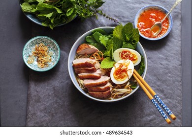 Vietnamese Pho With Duck With Crispy Skin, Bean Sprouts And Egg, Chili Sauce And Herbs