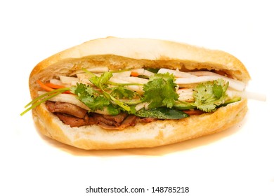 A Vietnamese Pork Sandwich on a bun with cilantro