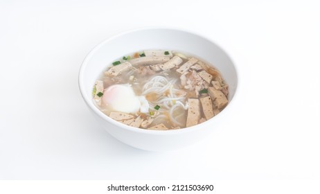 Vietnamese Rice Noodles Soup with soft-boiled eggs and parsley in white bowl on white background