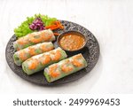 Gỏi cuốn, Vietnamese spring rolls, summer spring rolls, or salad spring rolls, a traditional dish in Vietnamese cuisine consisting of chicken, shrimp, vegetables, bún, and other ingredients wrapped in