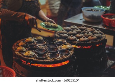 Vietnamese Street Food in the night - Banh can on the warm ember stove kitchen