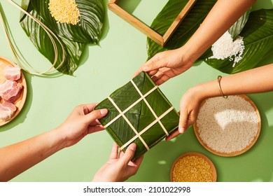 Vietnamese traditional Chung cake with dong leaf pork glutinous rice in green background for holiday food advertising , top view