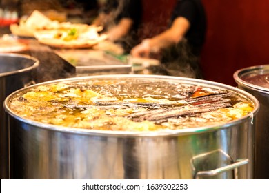 Vietnamese Traditional Pho Bo Soup Cooked In Boils In A Large Cauldron In An Open Restaurant Kitchen