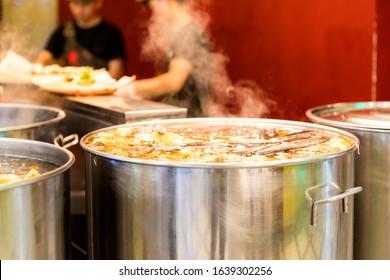 Vietnamese Traditional Pho Bo Soup Cooked In Boils In A Large Cauldron In An Open Restaurant Kitchen