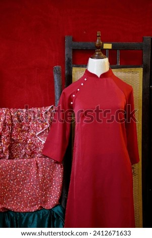 Vietnamese traditional red Ao Dai for Lunar New Year, displayed at a tailor shop