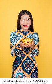 Vietnamese woman traditional festival costume Ao Dai. Tet holiday. Lunar New Year. Text mean rich.