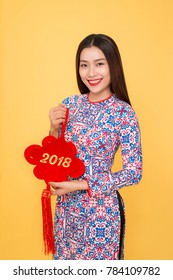 Vietnamese woman traditional festival costume Ao Dai holding attributes. Text mean Happiness.