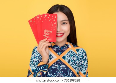 Vietnamese woman traditional festival costume Ao Da holding red money pockets. Tet holiday. Lunar New Year.