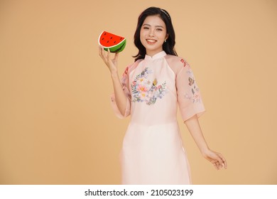 Vietnamese young lady in traditional robe for Lunar New Year Festival Season