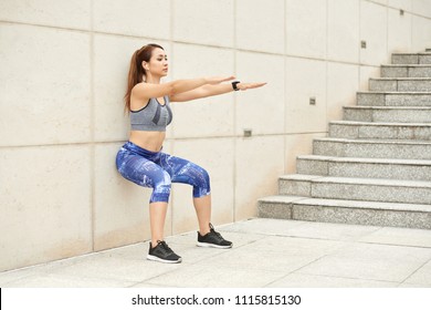 Vietnamese Young Woman Doing Wall Squat