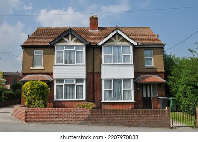 View of 1930s era semidetached houses on a residential street in an English city - Shutterstock ID 2207970833