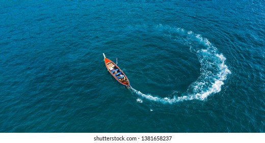 View from above, aerial view of a beautiful long tail boat sailing on a turquoise sea. Phi Phi Islands, Maya Bay, Krabi Province, Thailand.