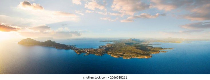 View from above, aerial shot, stunning panoramic view of Golfo Aranci during a beautiful sunrise. Golfo Aranci is a village that extends along a strip of land into turquoise sea. Sardinia, Italy. - Powered by Shutterstock