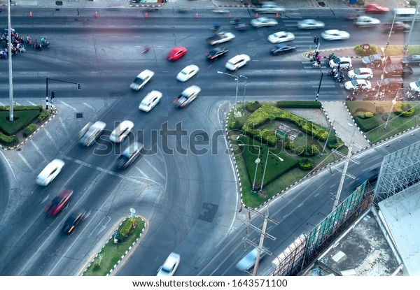 The\
view from above, cars and motorcycles are blurred, traveling on the\
highways, intersections commonly seen in the\
city.