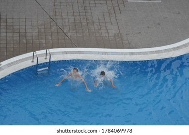 A View From Above, Children Jumped In The Swimming Pool In Tenerife, Canary Islands 