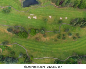 View From Above. City Park With Green Lawns, Bushes, Trees And Paved Roads, Car Parking Areas. Public Place, Place Of Recreation, Sports. There Are No People In The Photo.