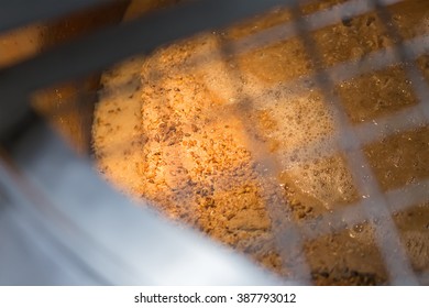 View From Above Of Craft Beer In Boiler With Malt Seeds From Railings.