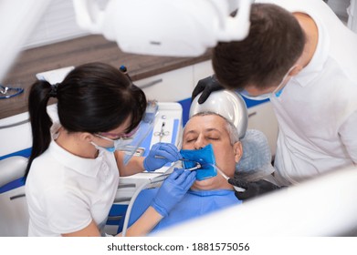 View From Above At Dentist Treating A Patient On A Dental Chair