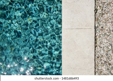 View From Above At The Edge Of The Swimming Pool With Clean Blue Water