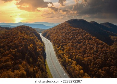 View from above of empty deserted I-40 freeway route in North Carolina leading to Asheville thru Appalachian mountains with yellow fall woods. Interstate transportation concept - Powered by Shutterstock