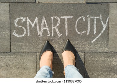 View From Above, Female Feet With Text Smart City Written On Grey Sidewalk