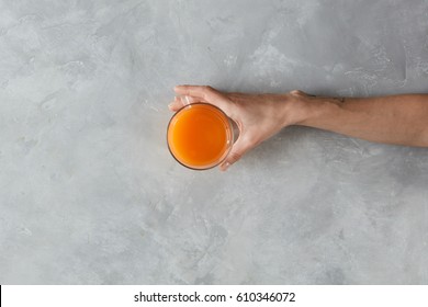 View From Above Of Female Hand Holding Glass Of Juice