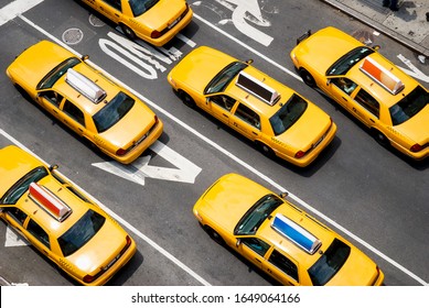 View from above of fleet of yellow taxi cabs driving down the street of Broadway in New York City