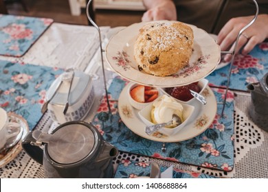 View From Above Of Fruit Scones, Jam And Cream, Known As Afternoon Tea In UK, Served On A Vintage Trays And Setting On A Table, Selective Focus.