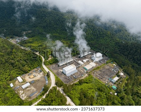 View from above of Geothermal power station with steam and pipes. Renewable energy production at a power station that supplies electricity in Mindanao, Philippines.