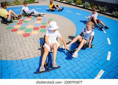 View From Above Of Group Of Six Children Playing And Recklessly Compete Little Racers In The School Yard. Activities For Kids, Games, Speed, Race, Imitation Of Road Markings.