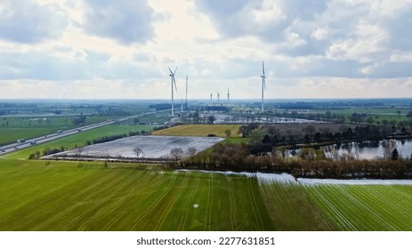 View from above on the German motorway A7 with some windmills for renewable electricity under construction