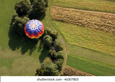 View from above on the hot air balloon flying over the fields and creek.