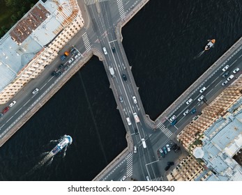 View From Above On Ismaylovsky Bridge Across Fontanka River. Blurred Car Motion On Bridge. A Pleasure Boat Is Floating On The Water. Close Up View From Above. Historical Center Of St Petersburg.