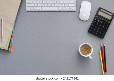 View From Above On The Office Working Place At Morning. Well Organized Workspace On The Grey Wooden Table With Keyboard, Pens, Coffee Mug And Other Business Supplies