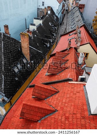 view from above on old tiled rooftops and chimneys in medieval European city
