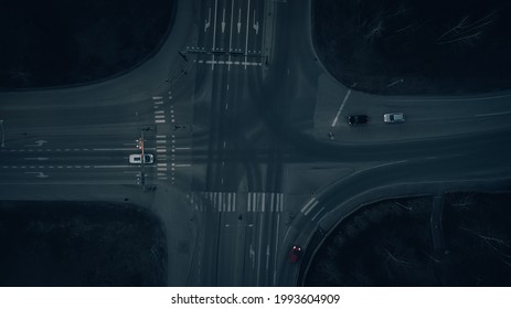 View from above on the road with markings and junction at night.