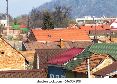 A view from above on the roofs of the old town of Mukachevo, on which sometimes there are still real chimney sweeps. Ukraine. - Shutterstock ID 646309108