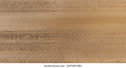 view from above on texture of dry muddy road with tractor tire tracks in countryside - Powered by Shutterstock